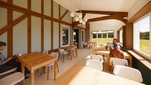 Enjoy meals in this airy dining area with a view of the lush landscape.