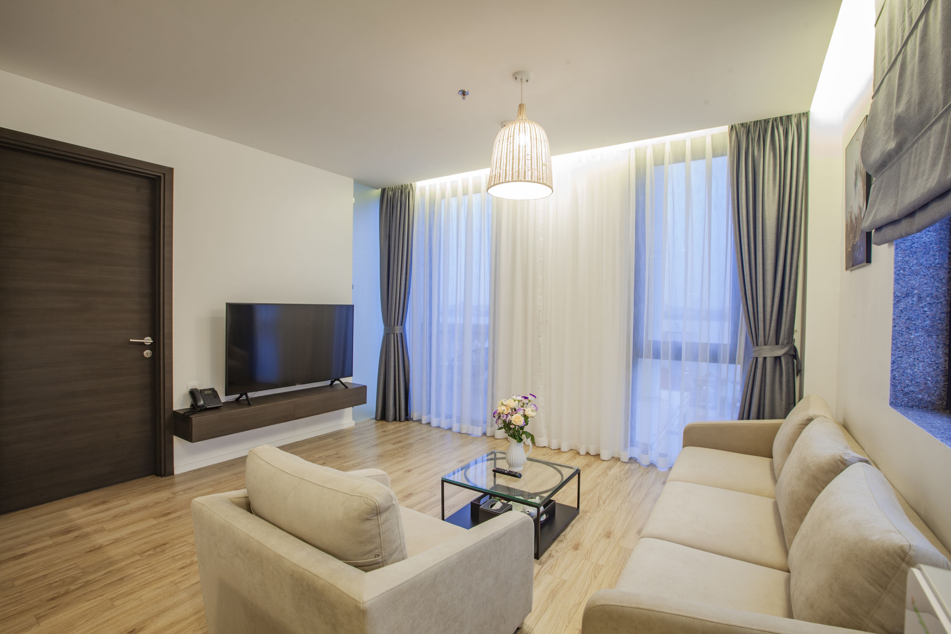 A modern living room with a sofa, coffee table, and TV.