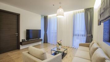 A modern living room with a sofa, coffee table, and TV.