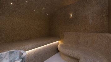 A room with a mosaic-tiled wall, a marble basin, and a curved seating area.