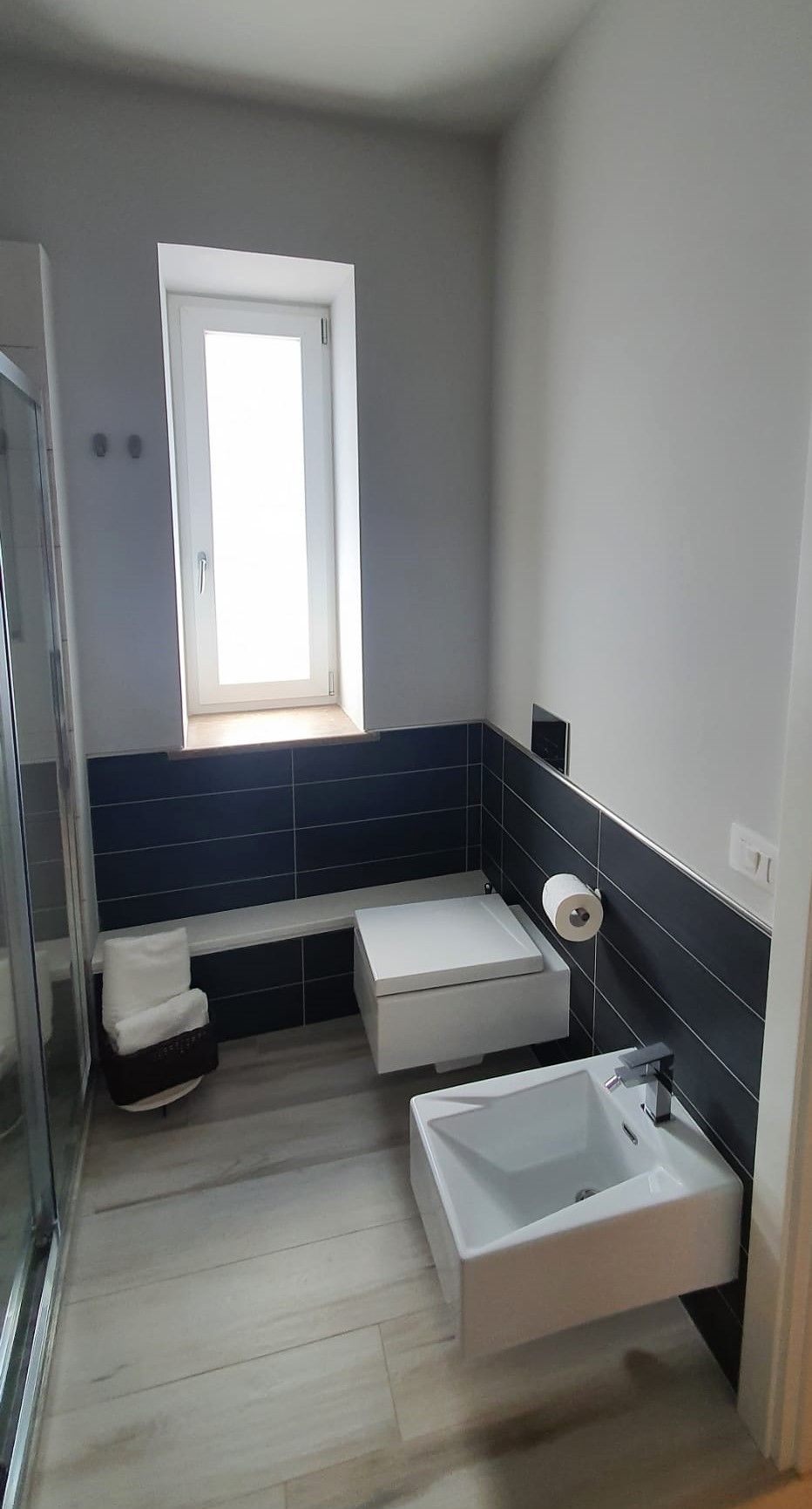 A modern bathroom with a toilet, bidet, and sink.