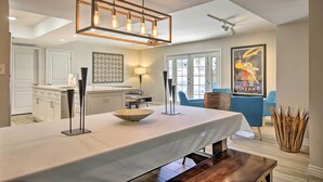 A modern kitchen with a large island, pendant lighting, and a dining area with a table and chairs. - 3 Mi to ASU: Tempe Getaway w/ Heated Pool (Tempe)