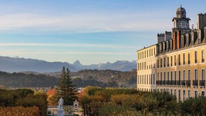 A building with a classical architectural style, featuring a prominent clock tower and multiple windows. - Clos Mirabel Manor B&B (Jurancon)