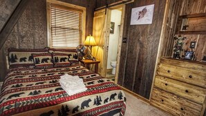 A bedroom with a bed featuring a bear and forest pattern, a wooden dresser, a fan, and a window with blinds. - Come SKI on the BEECH! Book your ski trip NOW, weekends going fast. (Beech Mountain)