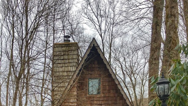 A wooden cabin with a triangular roof, a front door, and a small porch. - Come SKI on the BEECH! Book your ski trip NOW, weekends going fast. (Beech Mountain)
