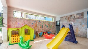 A children's play area with a slide, a small house, and a boat.