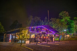 A restaurant with a play area for children, outdoor seating, and a bicycle parked outside.