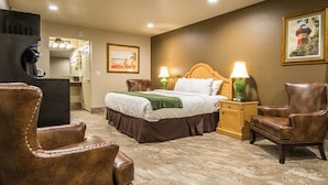 A hotel room with a bed, two nightstands with lamps, a chair, a desk, and a mirror. - The Gator Den Motel (Dunnellon)