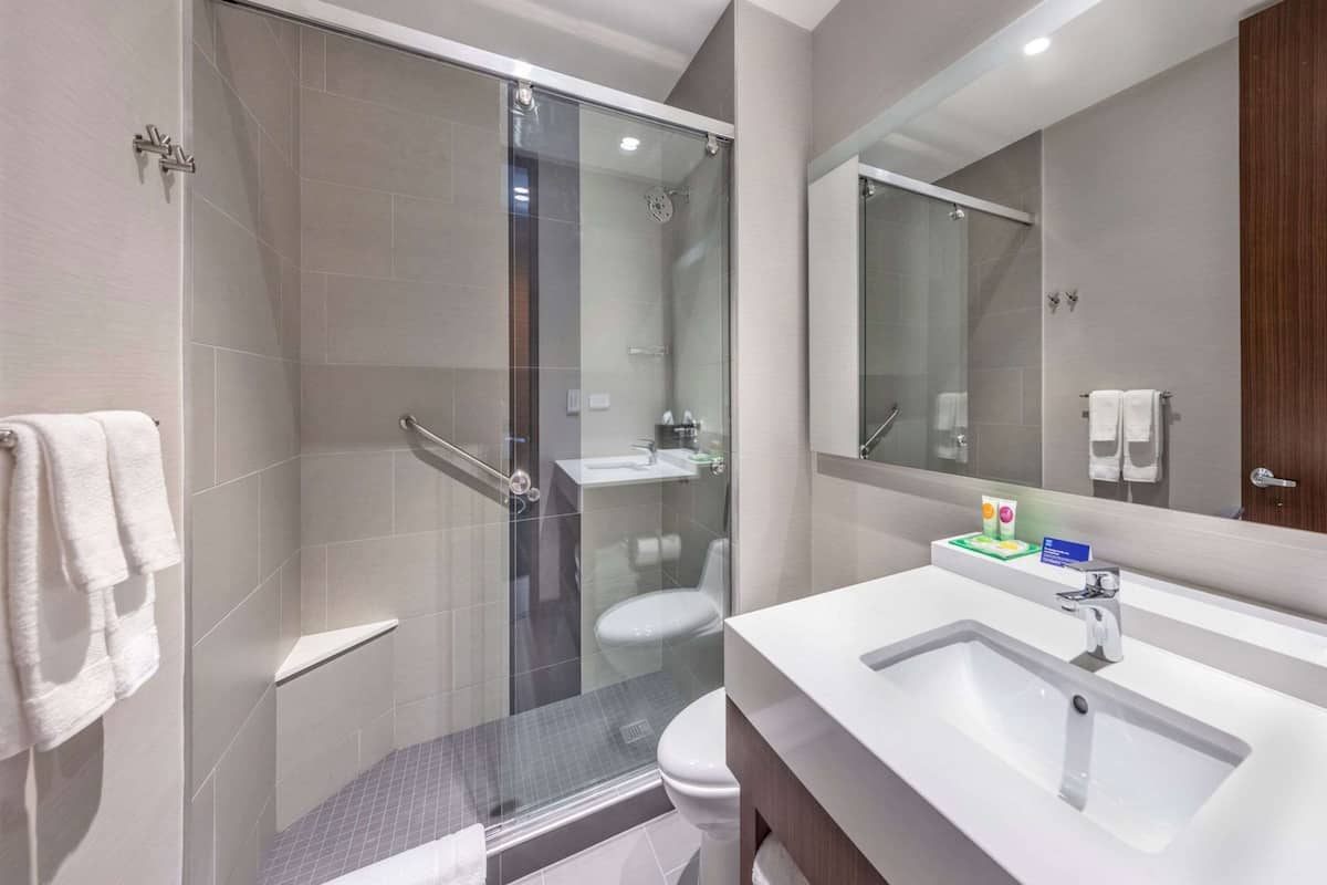 shower, rainfall showerhead, hair dryer, towels