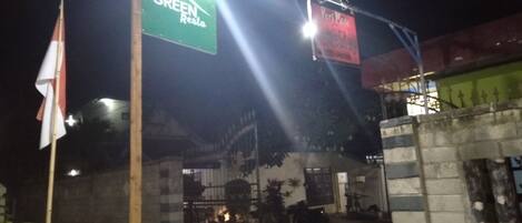 A gated entrance with a sign for 'GREEN RESTA' and another sign for 'Puri Made'.