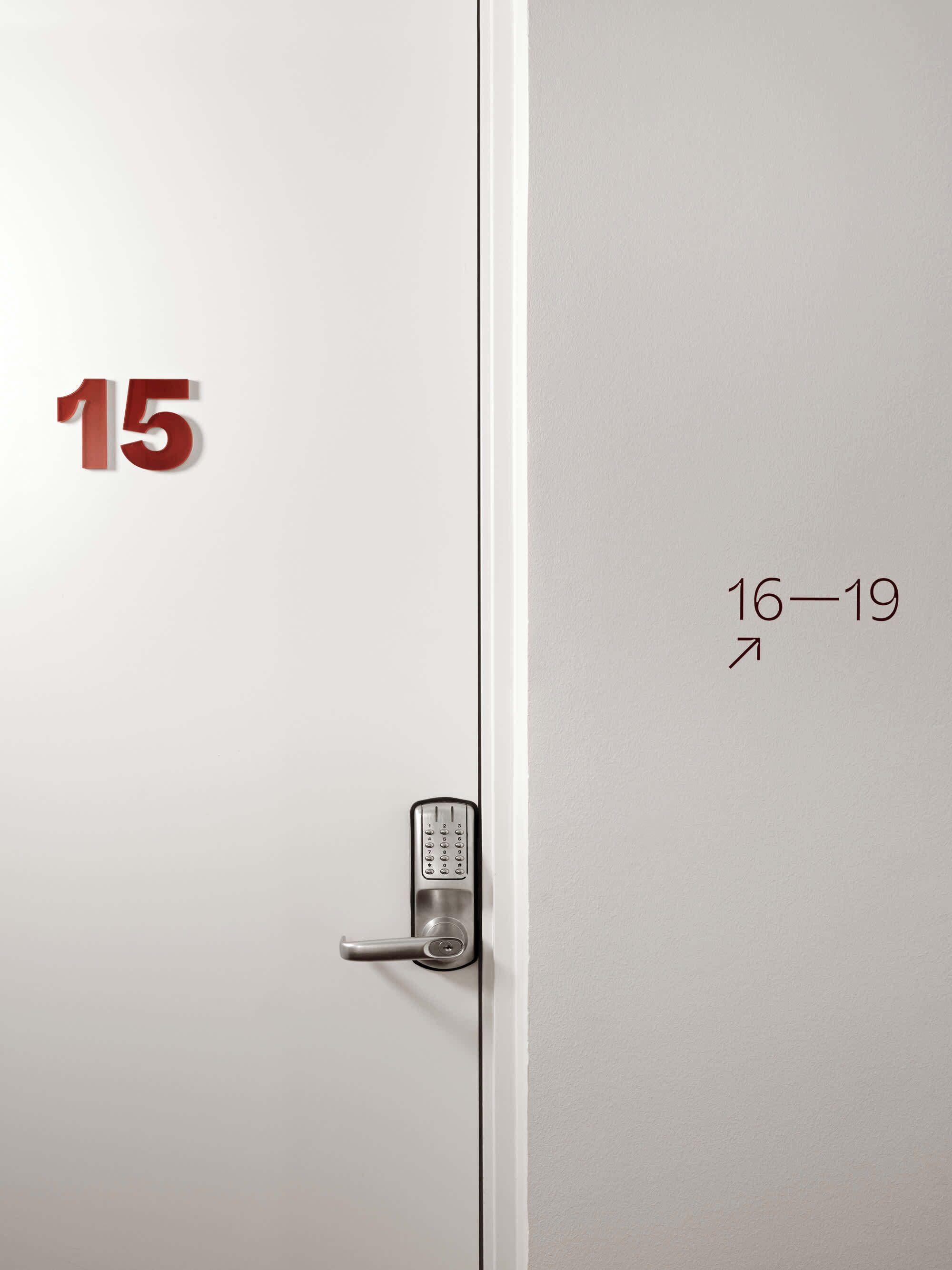A hotel room door with a numeric keypad lock and a number '15' on the left side.
