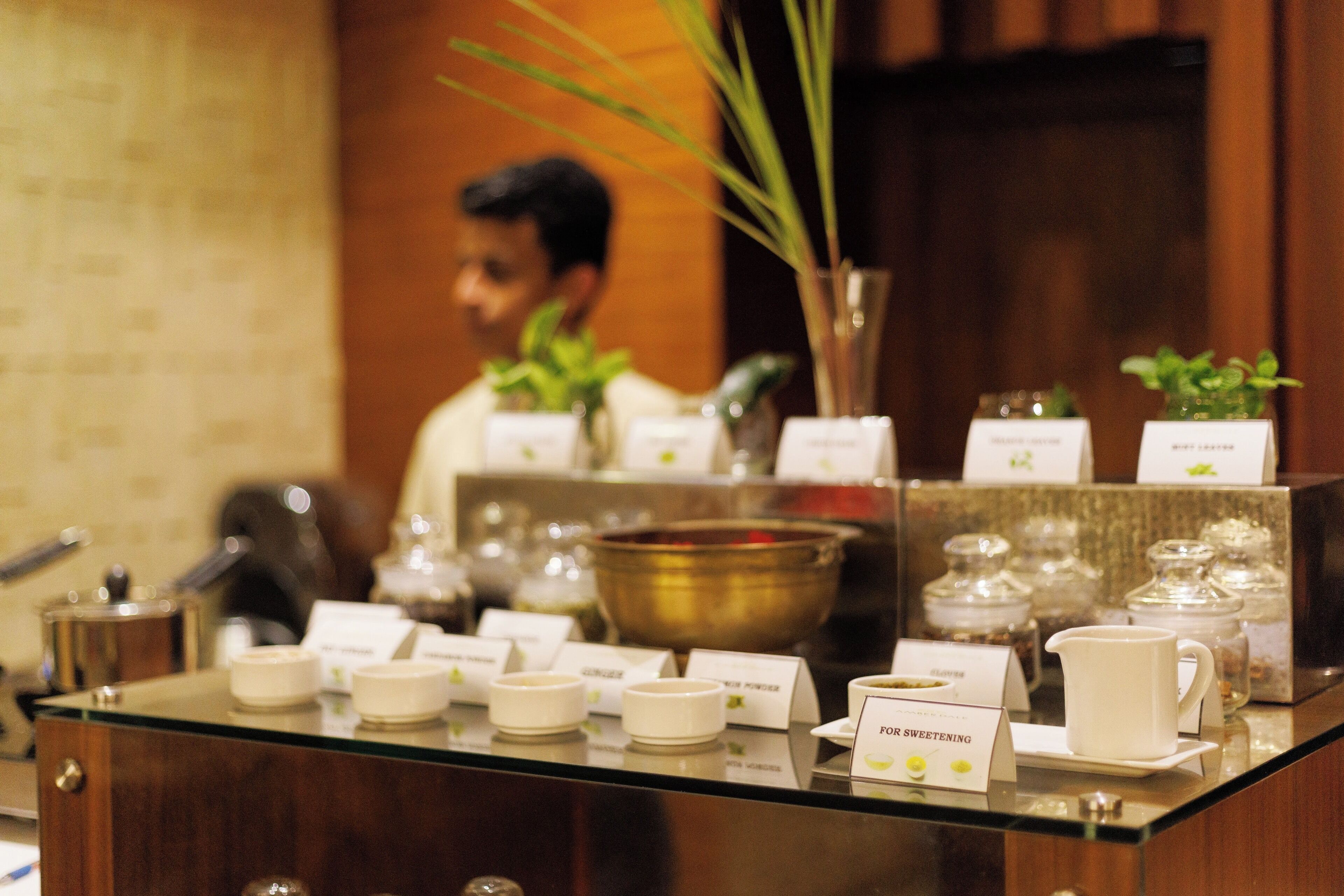 A buffet area with various food items and condiments.