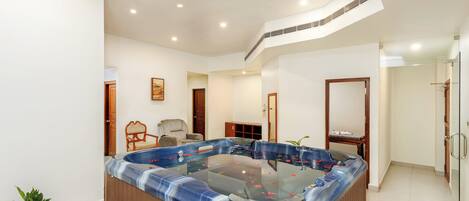 A modern bathroom with a freestanding bathtub, a shower area, and a toilet.