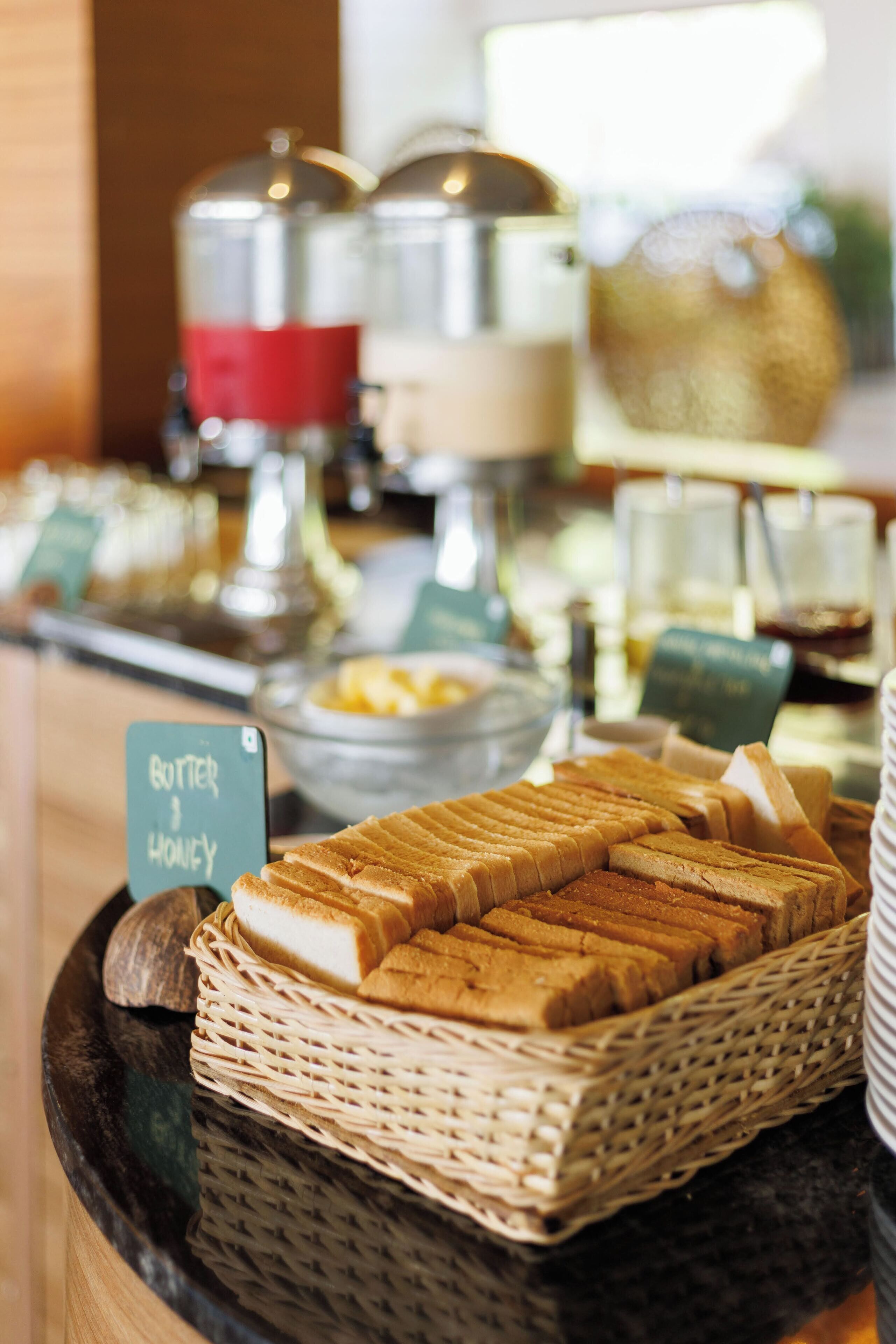 A breakfast buffet with bread, butter, and honey.