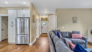 A modern kitchen with white cabinets and a stainless steel refrigerator. - Spacious Family Friendly SE, Free Parking, A/C, Walk to food, Toy Room, Crib! (Portland)