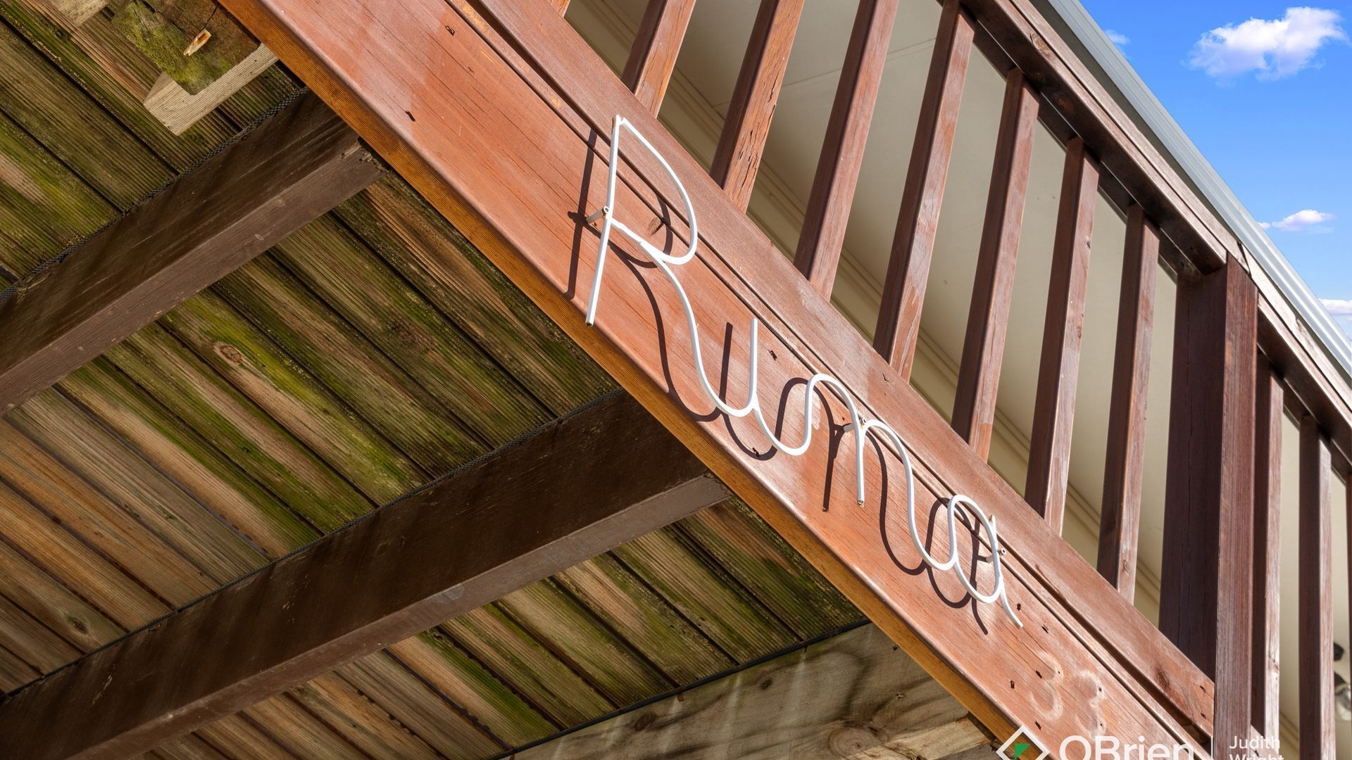 A wooden structure with the name "Rustic" carved into it.