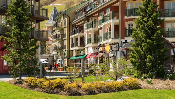 A multi-story hotel with balconies, a Starbucks, and a small garden area. - Blue Mountain Resort Home Collection (The Blue Mountains)