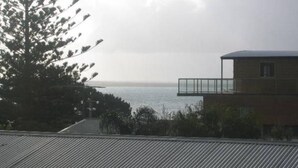 A building with a balcony overlooking a body of water. - Warley Hideaway (COWES)