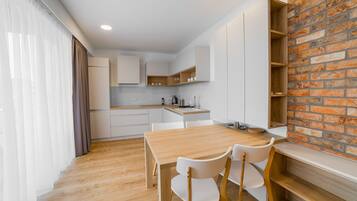 Comfort Apartment | Private kitchen | Full-size fridge, microwave, oven, stovetop