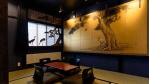 A traditional Japanese room with tatami flooring, a low table, and cushions. - Gojozaka Samurai Machiya, Gojozaka Samurai Machiya (Kyoto)