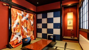 A traditional Japanese room with tatami flooring, a low table, and chairs. - Gojozaka Samurai Machiya, Gojozaka Samurai Machiya (Kyoto)