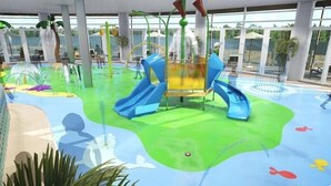An indoor water park with slides, a wave pool, and a play area. - Beautiful Lakeside lodge with Hot Tub (LINCON)