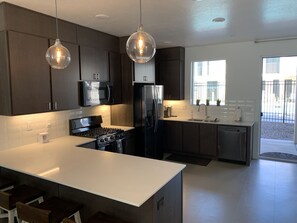 Microwave, dishwasher, coffee/tea maker, cookware/dishes/utensils