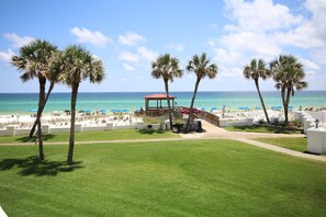 A beachside view with a gazebo, palm trees, and a white fence. - El Matador 324 -  FREE TICKETS!! Your stay includes free tickets to many area attractions! (Fort Walton Beach)