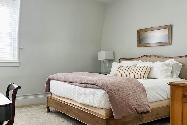 King bedroom with large closet, dresser, desk, full length mirror