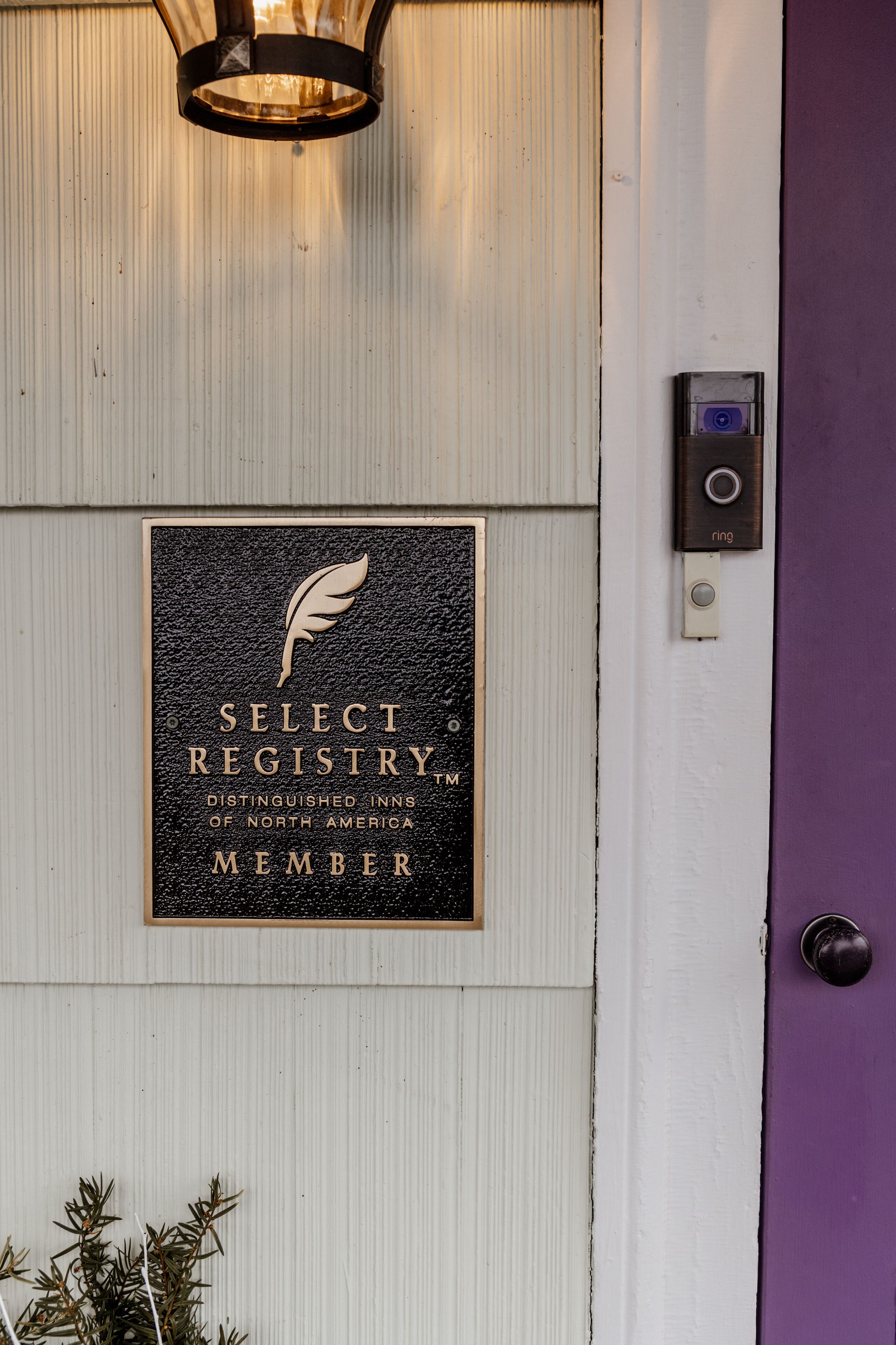 A plaque with the text "Select Registry Distinguishing Inns of North America Member" mounted on a wall.