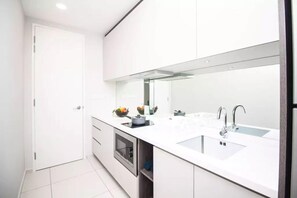 Full-sized fridge, microwave, stovetop, cookware/dishes/utensils