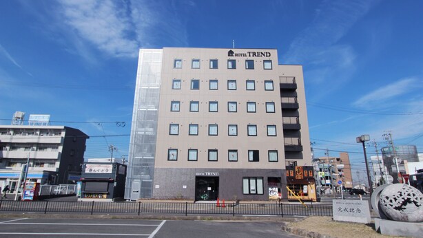 A multi-story hotel with a modern facade, a prominent sign reading "HOTEL TREND," and a parking lot in the foreground. - Hotel Trend Okazaki-Eki Mae (Okazaki)