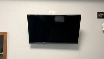 A flat-screen TV mounted on a white wall.