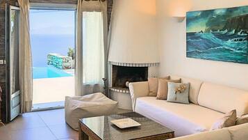 Exclusive Villa, Multiple Beds, Sea View | Living room | 46-cm flat-screen TV with satellite channels, TV, fireplace