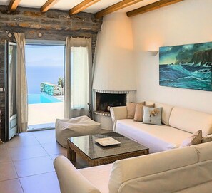 Exclusive Villa, Multiple Beds, Sea View | Living room | 46-cm flat-screen TV with satellite channels, TV, fireplace - Villa Sandra Maria (Kea)