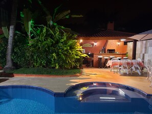 A pool area with a bar and outdoor seating.