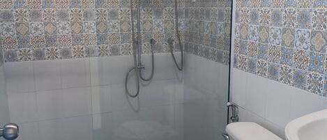 Un baño con ducha, inodoro y lavamanos.