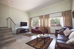 Chalet, 1 Bedroom, Garden View | Living room | 50-inch flat-screen TV with satellite channels, TV - The Chalets on 8th (Sandton)