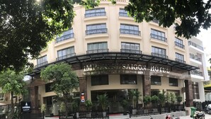 The Imperial Saigon Hotel facade with a curved entrance, multiple balconies, and surrounding greenery. - Imperial Saigon Hotel (Ho Chi Minh City)