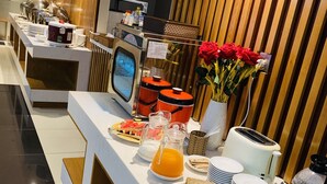A breakfast buffet with various food items, a coffee machine, and a toaster. - Imperial Saigon Hotel (Ho Chi Minh City)