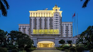 A large hotel with a prominent entrance, illuminated signage, and a flagpole. - Xinhui Country Garden Phoenix Hotel (Jiangmen)