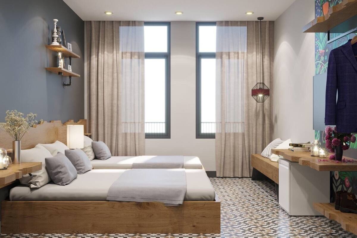 Una habitación de hotel moderna con una cama grande, un escritorio y una pequeña cocina.