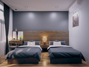 A modern bedroom with two beds, a desk, and a nightstand. - The G.Hotel Hue - Hostel (Hue)