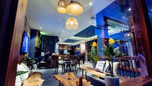 A modern interior with a bar area, wooden furniture, and hanging lights. - The G.Hotel Hue - Hostel (Hue)