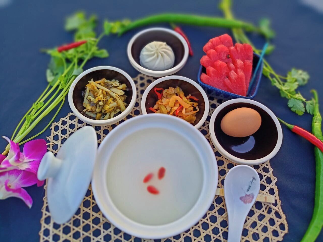 A table with various food items and a bowl of soup.