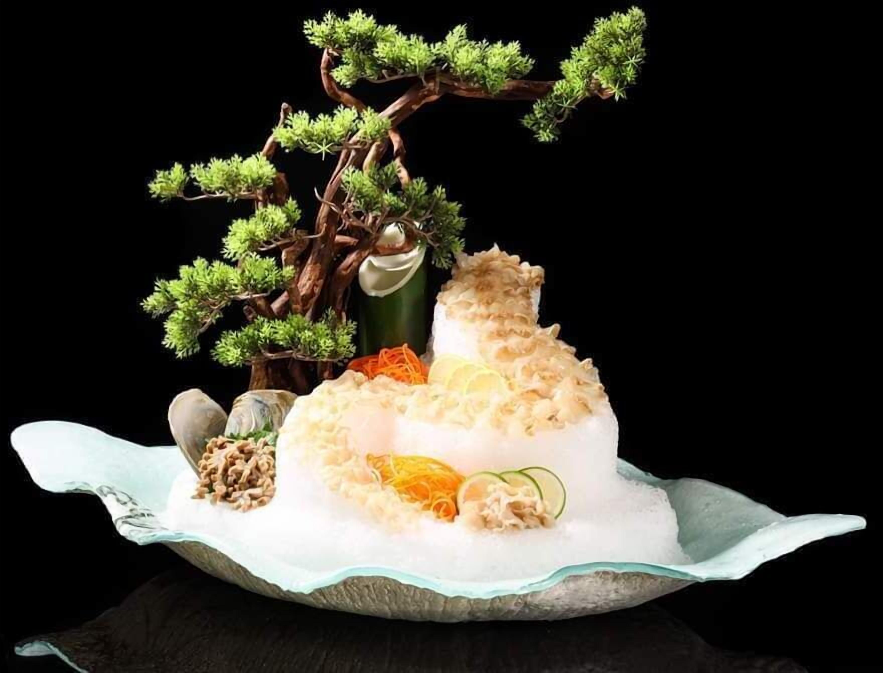 A dessert with a tree and fruits on a plate.