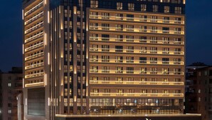 A modern hotel building with a prominent 'MÖVENPICK' sign at the top. It features multiple floors with balconies and large windows. - Mövenpick Diyarbakir (Diyarbakir)