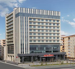 Stunning hotel building with a geometric facade and beautifully landscaped garden.
