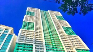 A high-rise building with multiple floors, featuring a grid of windows and balconies. - Green Residences (Manila)