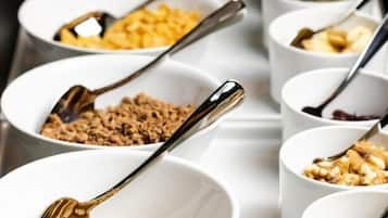 A series of white bowls with spoons, containing various food items.